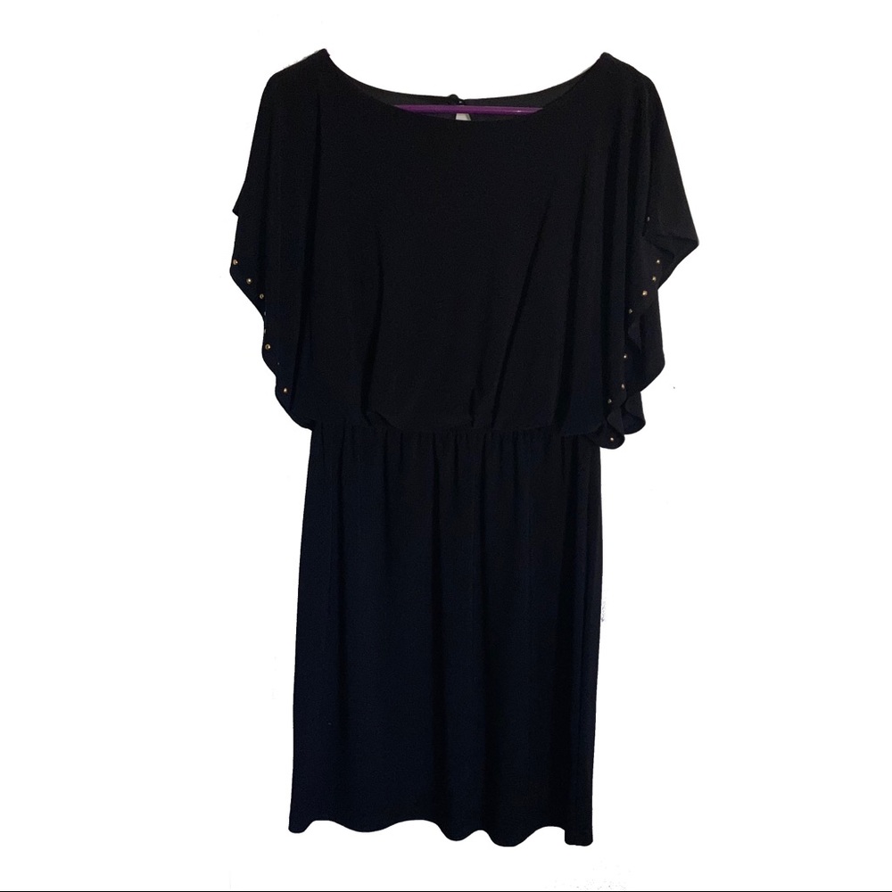 Black dress with gold studs alone